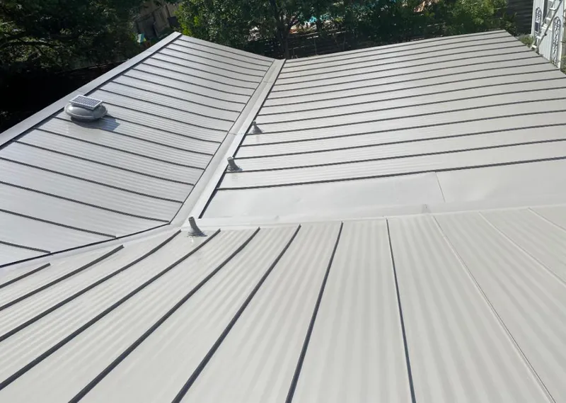 Solar attic fan installed on a metal roof for Roof Ventilation in Gouverneur